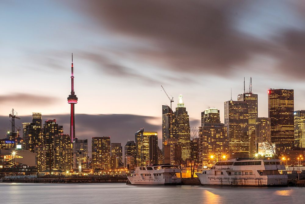 The Toronto skyline and CN Tower seen from Polson Pier at dusk